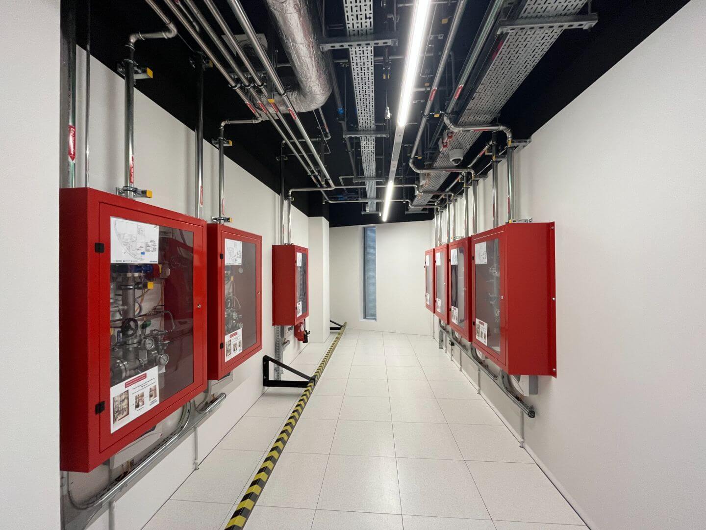 Data center corridor mechanical piping infrastructure